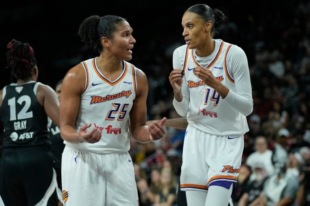 Phoenix Mercury forward DeWanna Bonner (14) and forward Alyssa Thomas talk during the second half in Game 1 of the WNBA basketball finals against the Las Vegas Aces, Friday, Oct. 3, 2025, in Las Vegas. (AP Photo/John Locher)