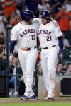Houston Astros' Victor Caratini (17) and Yainer Diaz (21) celebrate after the both scored on the RBI single by Jesus Sanchez against the Texas Rangers during the fourth inning of a baseball game Tuesday, Sept. 16, 2025, in Houston. (AP Photo/Michael Wyke)