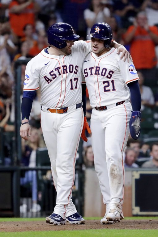 Houston Astros' Victor Caratini (17) and Yainer Diaz (21) celebrate after the both scored on the RBI single by Jesus Sanchez against the Texas Rangers during the fourth inning of a baseball game Tuesday, Sept. 16, 2025, in Houston. (AP Photo/Michael Wyke)