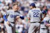 Los Angeles Dodgers pitcher Clayton Kershaw (22) is congratulated on the mound by Freddie Freeman, left, as he is replaced in the sixth inning of a baseball game against the Seattle Mariners, Sunday, Sept. 28, 2025, in Seattle. (AP Photo/John Froschauer)