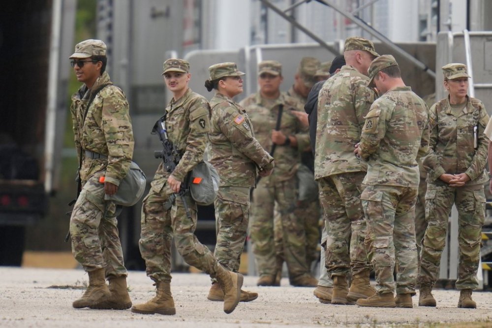 Military personnel in uniforms with the Texas National Guard patch at the U.S. Army Reserve Center are seen, Tuesday, Oct. 7, 2025, in in Elwood, Ill, a suburb of Chicago. (AP Photo Erin Hooley)
