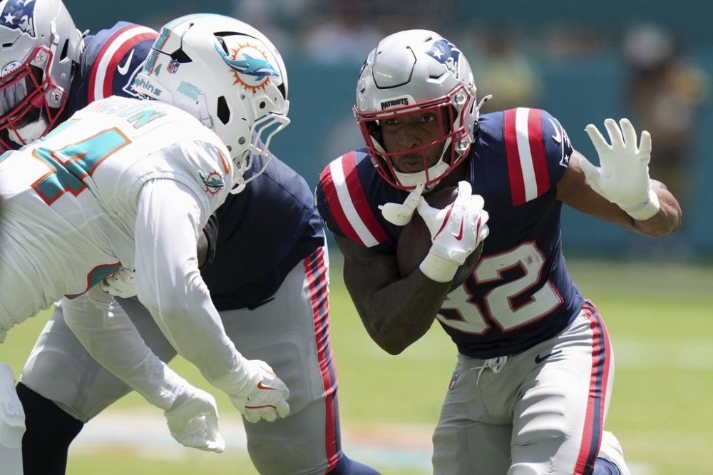 New England Patriots' TreVeyon Henderson runs during the half of an NFL football game against the Miami Dolphins Sunday, Sept. 14, 2025, in Miami Gardens, Fla. (AP Photo/Lynne Sladky)