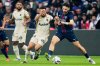 Lens' Adrien Thomasson, left, challenges for the ball with PSG's Khvicha Kvaratskhelia, right, during the French League One soccer match between Paris Saint-Germain and Lens at the Parc des Princes stadium in Paris, Sunday, Sept. 14, 2025. (AP Photo/Michel Euler)
