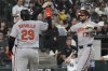 Baltimore Orioles' Colton Cowser, right, celebrates with Coby Mayo and Samuel Basallo (29) after hitting a three-run home run during the sixth inning of a baseball game against the Chicago White Sox in Chicago, Monday, Sept. 15, 2025. (AP Photo/Nam Y. Huh)