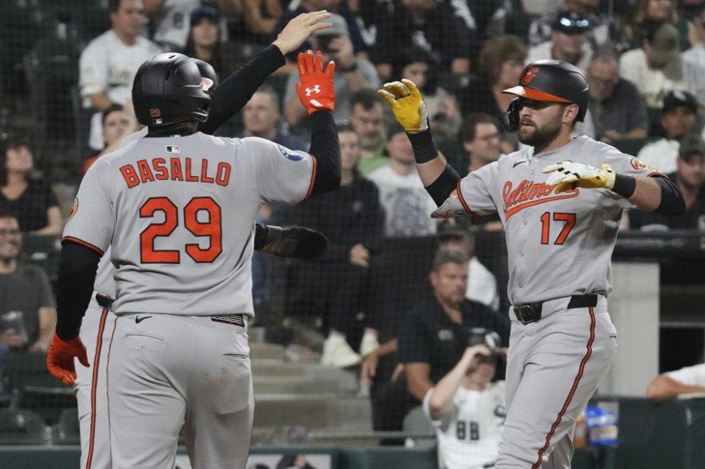 Baltimore Orioles' Colton Cowser, right, celebrates with Coby Mayo and Samuel Basallo (29) after hitting a three-run home run during the sixth inning of a baseball game against the Chicago White Sox in Chicago, Monday, Sept. 15, 2025. (AP Photo/Nam Y. Huh)