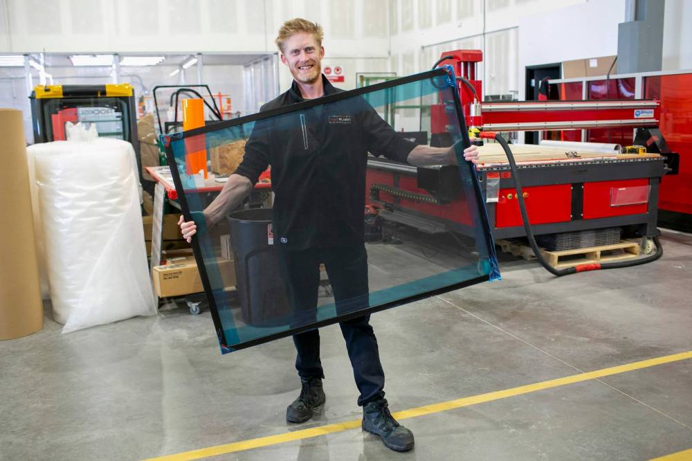 BROOK JONES / FREE PRESS
general manager Marcus Williams shows off a sheet of RockScreen (a product comprised of woven stainless steel with a black powder-coated finish).