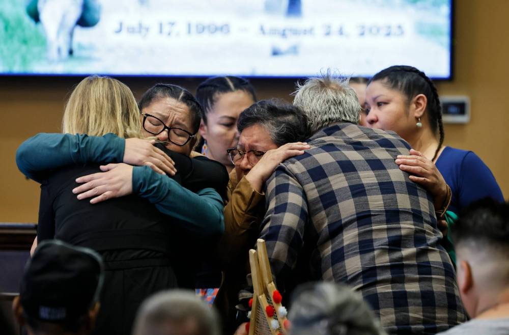 JOHN WOODS / FREE PRESS
Madeline Hunter, left, and her mother Jeanie Hunter embrace the parents as family and friends gather at a memorial for Steffen Skjottelvik at Chapel Lawn Funeral Home in Headingley on Monday.