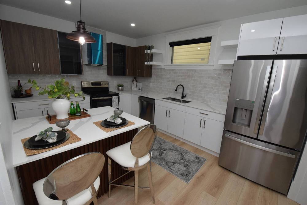 Spacious and modern, the eat-in kitchen comes with a compact island that seats two, two-tone cabinets, quartz countertops and new stainless appliances.