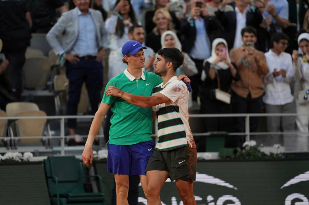 Thibault Camus / Associated Press files
In this June 2025 photo, Carlos Alcaraz (right) hugs Jannik Sinner after defeating him in the French Open final. Sinner would return the favour in July at Wimbledon.