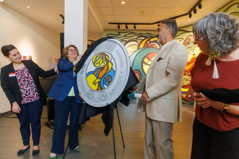 MIKE DEAL / FREE PRESS
An enlarged replica showcasing the art printed on the coin is unveiled by (from left) Dorota Blumczynska CEO of the Manitoba Museum, Marie Lemay CEO of the Royal Canadian Mint, Stan Somerville, the son of artist Daphne Odjig, and Ginette Lavack, MP for St. Boniface-St. Vital and Parliamentary Secretary to the Minister of Indigenous Services.