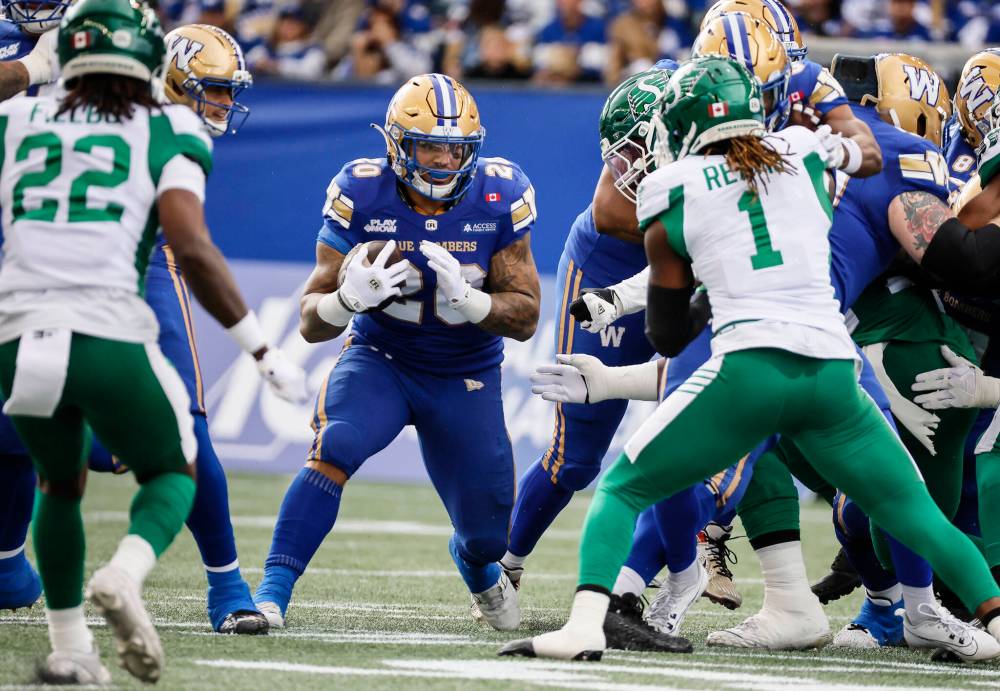 JOHN WOODS / THE CANADIAN PRESS
Winnipeg Blue Bombers’ Brady Oliveira (20) runs for the first down against the Saskatchewan Roughriders during first half CFL action in Winnipeg, Saturday, Sept. 6, 2025.