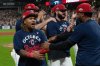 Cleveland Guardians' Jose Ramirez, left, celebrates with his teammates after securing an American League playoff spot at the end of a baseball game against the Texas Rangers, Saturday, Sept. 27, 2025, in Cleveland. (AP Photo/Phil Long)