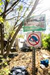 MIKAELA MACKENZIE / FREE PRESS
                                A no tenting sign along the river south of the Alexander Docks on Thursday, Sept. 25, 2025. For 49.8 story. Free Press 2025
