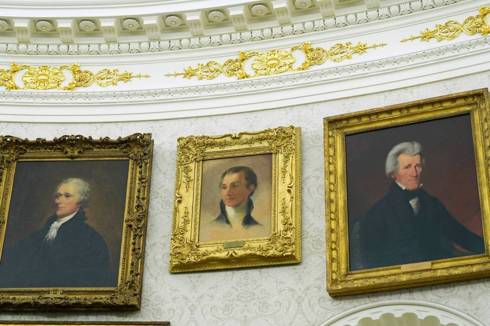 A detail of gold leaf in the crown work over pairings of president Alexander Hamilton, president James Monroe and president Andrew Jackson in the Oval Office. (Alex Brandon / The Associated Press files)