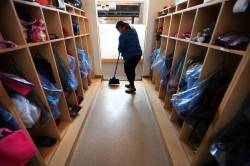 RUTH BONNEVILLE / FREE PRESS FILES
                                49.8 Feature photos on Early Childhood Educators working with kids at Splash Child Enrichment Centre on McGregor Street. More info to follow. Early childhood educator Sharon Desamero sweeps up the locker area at centre. See Mary Agnes Welch story. April 28, 2015