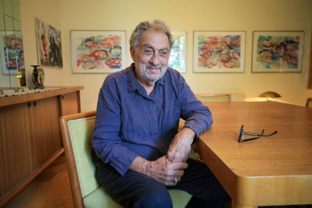RUTH BONNEVILLE / FREE PRESS
Gilles Hébert, interim executive director of Plug In ICA, displays his suite of four paintings by Carolee Schneemann in his North End home.