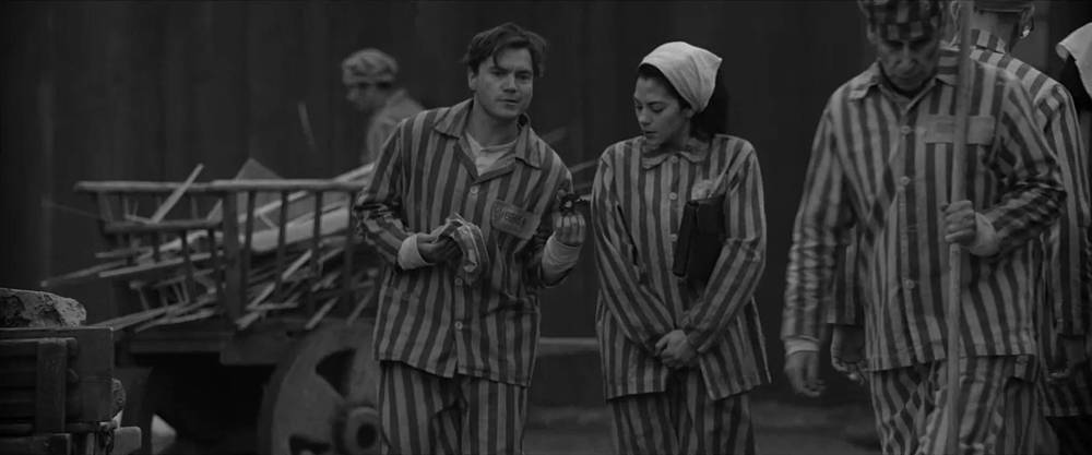 SUPPLIED
Joseph Bau (Emile Hirsch, left) gives Rebecca (Inbar Lavi) a flower in a scene from Bau, Artist at War, which opens Friday.