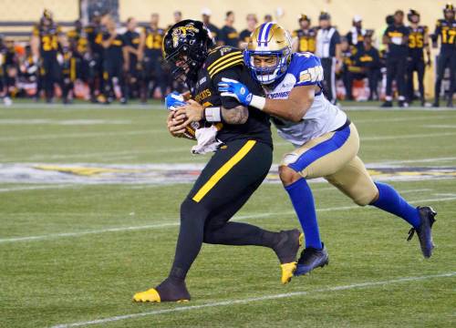 Peter Power / THE CANADIAN PRESS
                                Bombers linebacker Kyrie Wilson (right) tracks down Tiger-Cats quarterback Bo Levi Mitchell.