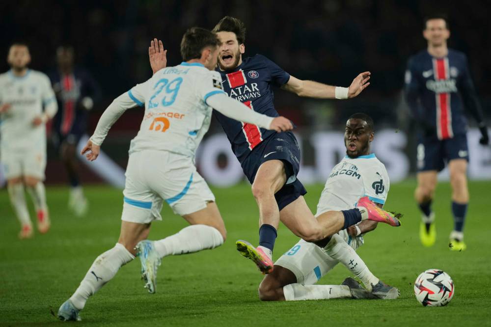 CHRISTOPHE ENA / THE ASSOCIATED PRESS FILES
Paris Saint-Germain’s Khvicha Kvaratskhelia (centre) challenges for the ball with Marseille’s Geoffrey Kondogbia (right) and Pol Lirola, the last time the two clubs met back in March. Historically, the most infamous Le Classique occurred in December 1992 with more than 50 fouls committed, while, more recently, in 2020, a full-scale brawl broke out.