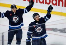 JOHN WOODS / WINNIPEG FREE PRESS
                                Winnipeg Jets’ Danny Zhilkin (53) and Kevin He (46) celebrate Zhilkinճ goal against the Minnesota Wild during first period pre-season NHL action in Winnipeg on Sunday, September 21, 2025.
