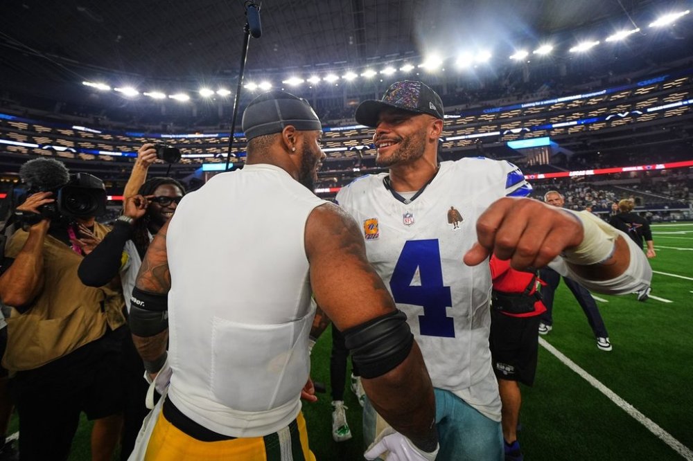 Green Bay Packers defensive end Micah Parsons, left, and Dallas Cowboys quarterback Dak Prescott (4) greet each other after their team's overtime NFL football game which ended in a tie Sunday, Sept. 28, 2025, in Arlington, Texas. (AP Photo/Julio Cortez)