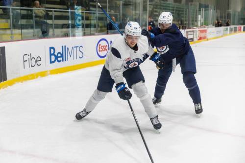 MIKE DEAL / FREE PRESS
                                Winnipeg Jets’ Ville Heinola (left) battles for the puck against Ashton Sautner at training camp on Thursday. The defenceman firmly believes his best hockey is ahead of him after recovering from injuries.