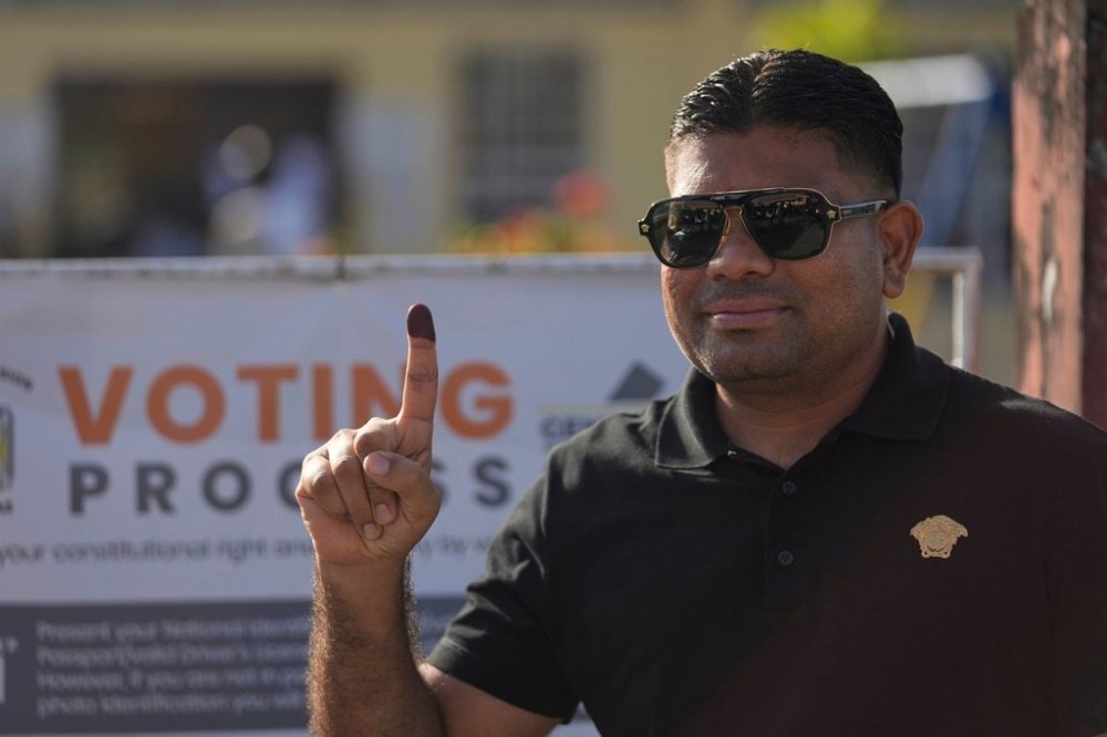 FILE - Presidential candidate Azruddin Mohamed of the We Invest in Nationhood party displays his ink-stained finger after voting in general elections in Georgetown, Guyana, Sept. 1, 2025. (AP Photo/Matias Delacroix, File)