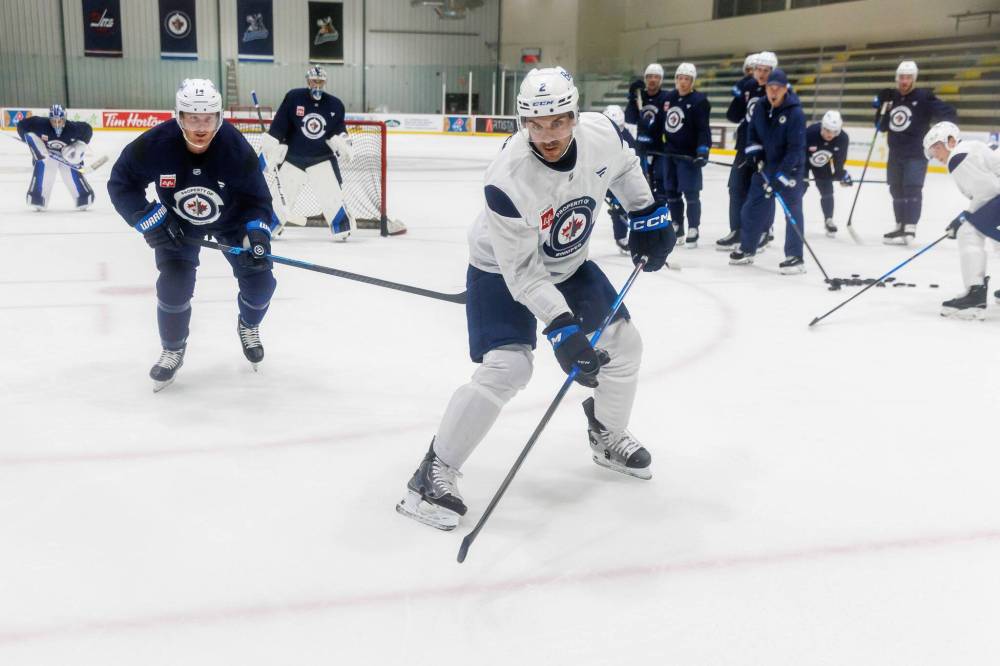 MIKE DEAL / FREE PRESS
Part of Winnipeg Jets defenceman Dylan DeMelo’s (centre) plans for this season is for him and his linemate, Josh Morrissey, to be the best pair in the league.