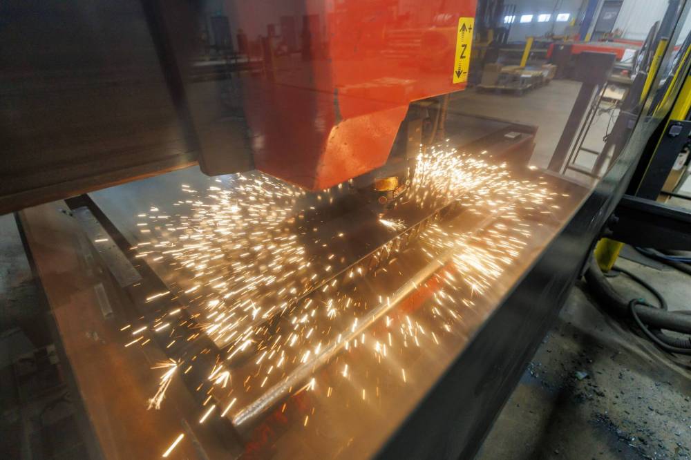 MIKE DEAL / FREE PRESS
A laser cutter at work on a sheet of steel at the NJ Industries Inc. shop at 30 Harvest Dr. The company recently completed a $1.5 million expansion to its facilities, which allowed it to add a HSG TS2 tube laser.