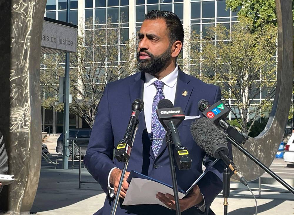 RUTH BONNEVILLE / FREE PRESS
Obby Khan answers questions from the media outside the Law Courts on Friday.