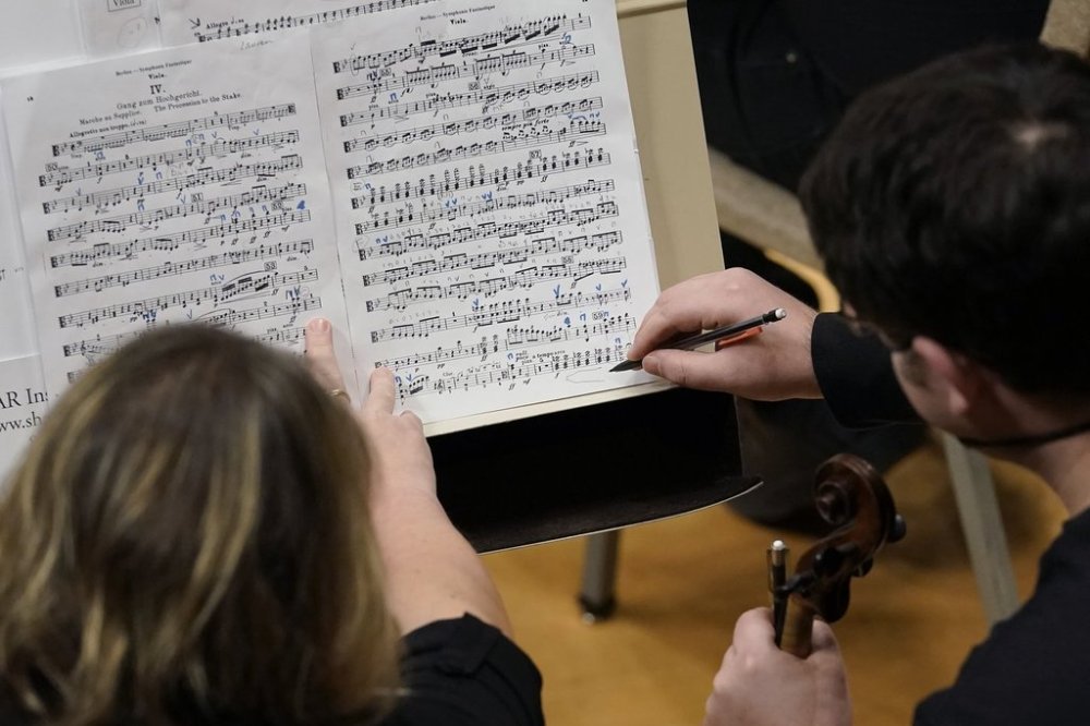 Musicians review sheet music during an orchestra rehearsal in Boston on Sunday, Jan. 23, 2022. THE CANADIAN PRESS/AP/Steven Senne