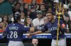 Seattle Mariners' Eugenio Suárez (28) is congratulated by Julio Rodríguez after hitting a solo home run during the fourth inning of a baseball game against the Houston Astros, Friday, Sept. 19, 2025, in Houston. (AP Photo/Kevin M. Cox)