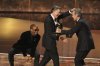Bryan Cranston, right, presents the award for outstanding talk series to Stephen Colbert, left, for 