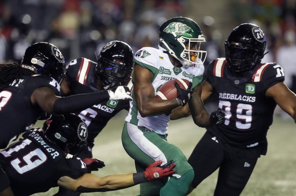 Ottawa Redblacks players bring down Saskatchewan Roughriders wide receiver Shawn Bane Jr. (15) as he returns a punt during first half CFL action in Ottawa on Friday, Oct. 3, 2025. THE CANADIAN PRESS/Adrian Wyld