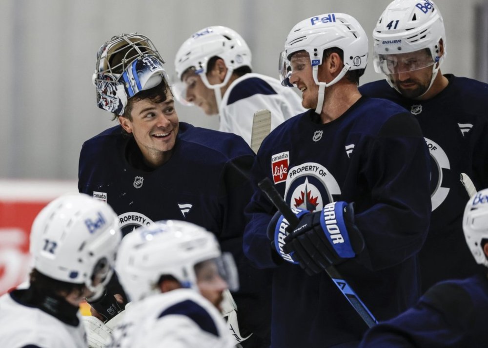 Jets goaltender Eric Comrie (1) talks to Gustav Nyquist (14) during their NHL training camp session in Winnipeg on Thursday, Sept. 18, 2025. THE CANADIAN PRESS/John Woods