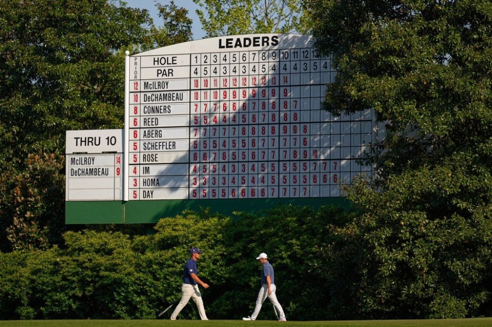 FILE - Bryson DeChambeau, left, and walk Rory McIlroy, of Northern Ireland, walk on the 11th hole during the final round at the Masters golf tournament, April 13, 2025, in Augusta, Ga. (AP Photo/George Walker IV, file)