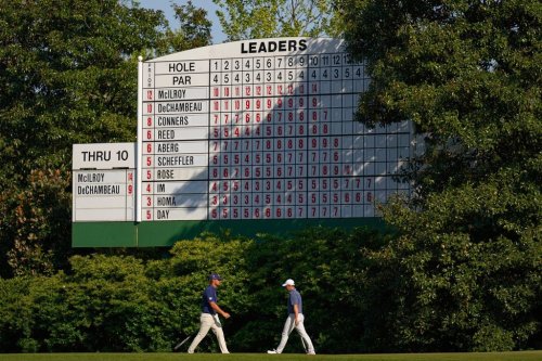 FILE - Bryson DeChambeau, left, and walk Rory McIlroy, of Northern Ireland, walk on the 11th hole during the final round at the Masters golf tournament, April 13, 2025, in Augusta, Ga. (AP Photo/George Walker IV, file)