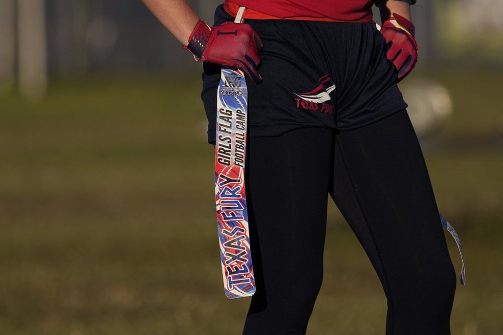 A player holds her belt and flag during a practice with Texas Fury, an all-girls flag football select travel team, Sunday, Dec. 10, 2023, in Austin, Texas. (AP Photo/Eric Gay)