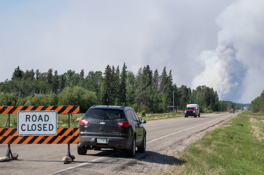Highway 106 is closed as wildfires burn near Smeaton, Sask., on Wednesday, June 4, 2025. THE CANADIAN PRESS/Liam Richards