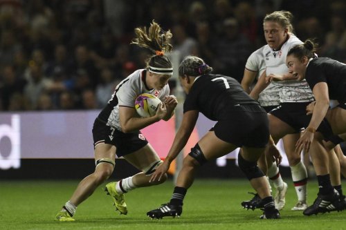 Canada's Karen Paquin, left, and New Zealand's Kennedy Tukuafu challenge for the ball during the Women's Rugby World Cup 2025 semifinal match between New Zealand and Canada in Bristol, England, Friday, Sept. 19, 2025.(AP Photo/Anthony Upton)
