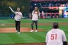 CORRECTS FIRST NAME TO RYAN, NOT MATT - Braden Halladay, left, accompanied by his brother Ryan Halladay, throws a ceremonially first pitch to former Philadelphia Phillies catcher Carlos Ruiz, marking the 15th anniversary of their father Roy Halladay's postseason no-hitter, ahead of Game 2 of baseball's National League Division Series between the Phillies and the Los Angeles Dodgers, Monday, Oct. 6, 2025, in Philadelphia. (AP Photo/Matt Rourke)
