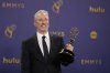 FILE - Jon Stewart poses in the press room with the award for outstanding talk series for 