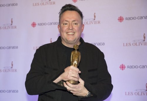 Mike Ward holds up his trophy at the Gala Olivier awards ceremony in Montreal, Sunday, Dec. 8, 2019. THE CANADIAN PRESS/Graham Hughes