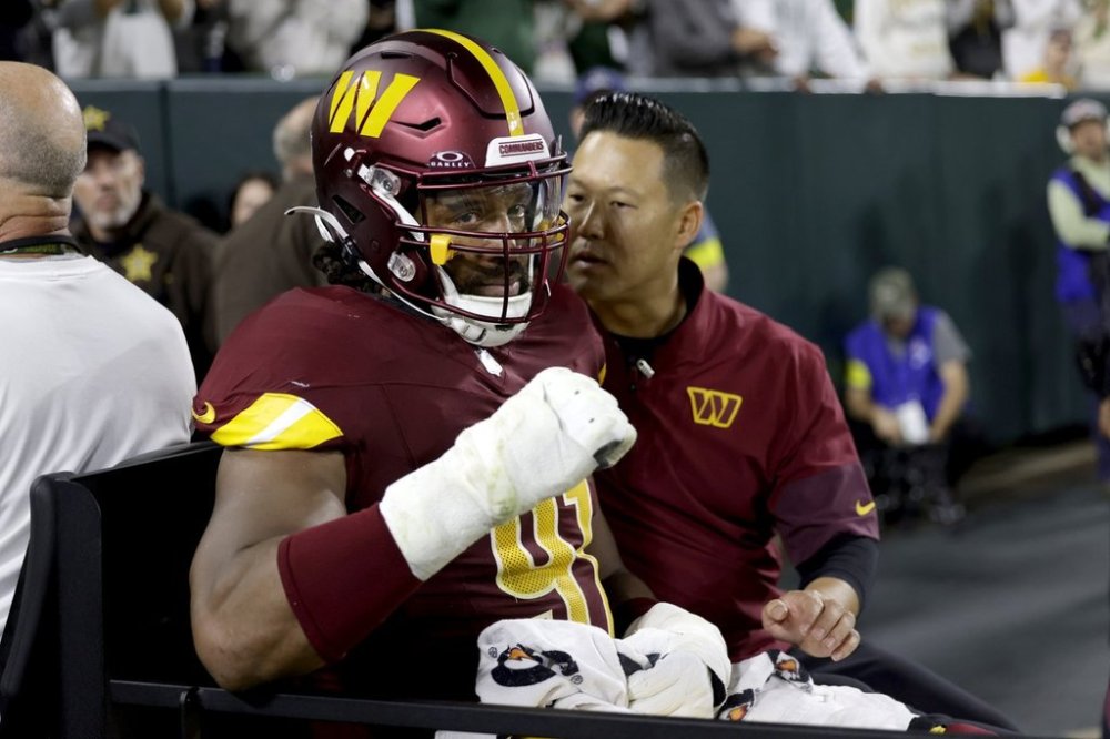 Washington Commanders defensive end Deatrich Wise (91) is taken off on a cart after being injured during the first half of an NFL football game against the Green Bay Packers Thursday, Sept. 11, 2025, in Green Bay, Wis.(AP Photo/Matt Ludtke)