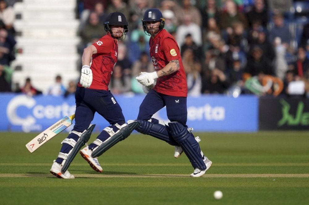 England's Jordan Cox, left, and Phil Salt run between the wickets during the third men's International Twenty20 cricket match at Malahide Cricket Club in Dublin, Ireland, Sunday Sept. 21, 2025. (Brian Lawless/PA via AP)