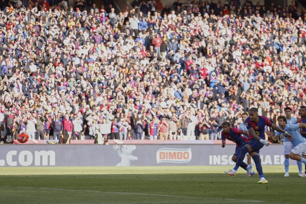 FILE -Barcelona's Raphinha shoots a penalty kick to score during a Spanish La Liga soccer match between Barcelona and Celta de Vigo at the Lluis Companys Olympic stadium in Barcelona, Spain, April 19, 2025. (AP Photo/Joan Monfort, File)