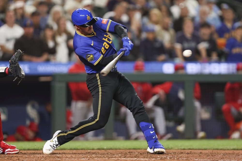 Seattle Mariners' Mitch Garver hits a home run against the Los Angeles Angels during seventh inning of a baseball game Friday, Sept. 12, 2025, in Seattle. (AP Photo/Kevin Ng)