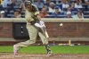 San Diego Padres' Manny Machado hits a grand slam during the fifth inning of a baseball game against the New York Mets Wednesday, Sept. 17, 2025, in New York. (AP Photo/Frank Franklin II)