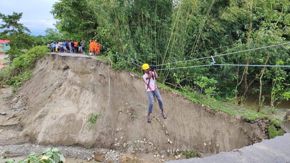 A person is evacuated with the help of a temporary zip line laid by the National Disaster Response Force (NDRF) following multiple landslides triggered by torrential rains near Jalpaiguri in the Indian state of West Bengal, Sunday, Oct. 5, 2025. (The National Disaster Response Force vis AP)