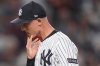 New York Yankees pitcher Luke Weaver reacts as he walks off the field after giving up two runs to the Boston Red Sox during the seventh inning of Game 1 of an American League wild-card baseball playoff series, Tuesday, Sept. 30, 2025, in New York. (AP Photo/Frank Franklin II)
